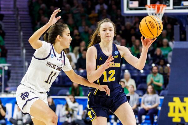 Michigan guard Syla Swords (12) passes the ball as Notre Dame guard Sonia Citron (11) defends during the second half in the second round of the NCAA college basketball tournament, Sunday, March 23, 2025, in South Bend, Ind. (AP Photo/John Mersits)