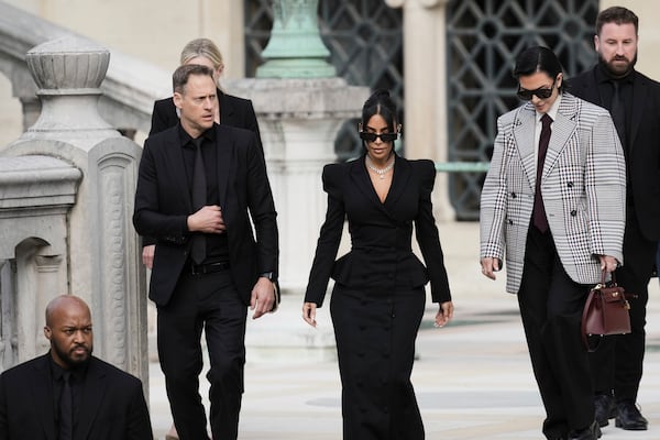 Kim Kardashian, center, accompanied by her mother Kris Jenner, second right, leaves the justice palace after testifying, regarding a robbery of millions of dollars in jewels from her Paris hotel room in 2016, in Paris, Tuesday, May 13, 2025. (AP Photo/Aurelien Morissard)