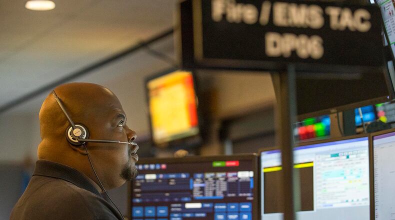 Dispatcher Orderryl Williams speaks with members from Fulton County Fire and EMS at the Fulton County Emergency Communications office in Atlanta. The Fulton County Emergency Communications handles 911 calls from the city of Fairburn, South Fulton, Union City, Chattahoochee Hills, Palmetto and unincorporated Fulton County. (Alyssa Pointer/alyssa.pointer@ajc.com)