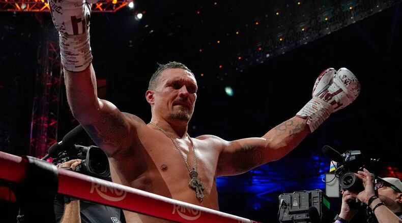 FILE - Ukraine's Oleksandr Usyk celebrates winning the undisputed world heavyweight boxing title fight against Britain's Daniel Dubois in London, July 19, 2025. (AP Photo/Frank Augstein, File)