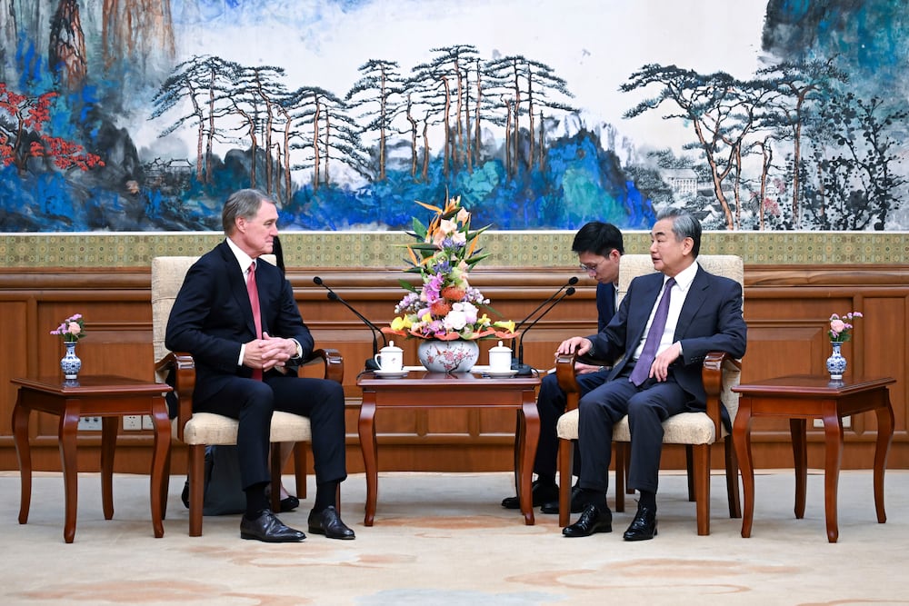 Chinese Foreign Minister Wang Yi (right) talked to new U.S. Ambassador to China David Perdue during a meeting last month in Beijing.