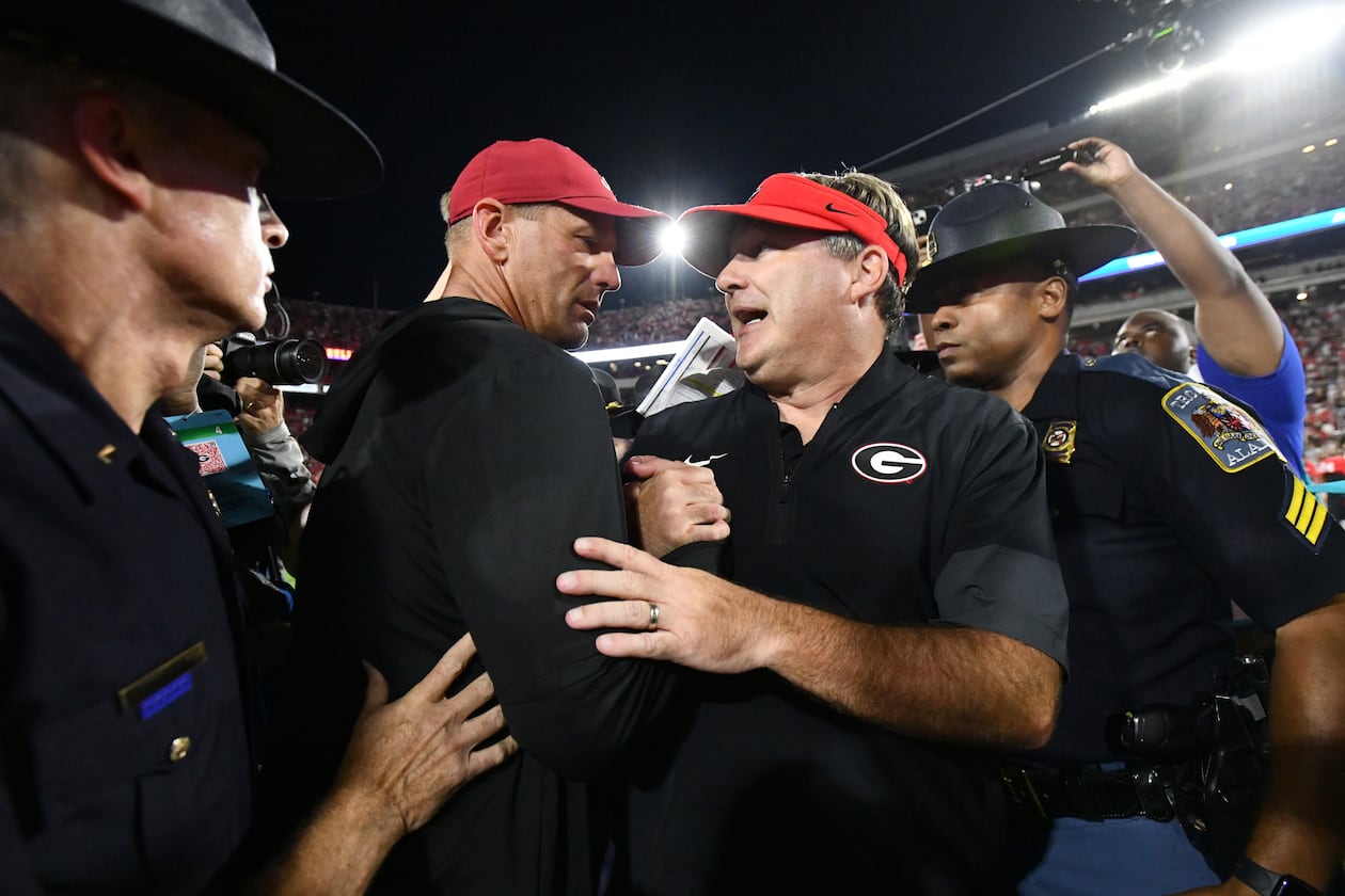 Georgia head coach Kirby Smart (right) and Alabama head coach Kalen DeBoer shake hands after Alabama beat Georgia in an NCAA football game at Sanford Stadium, Saturday, Sept. 27, 2025, in Athens. (Hyosub Shin/AJC)