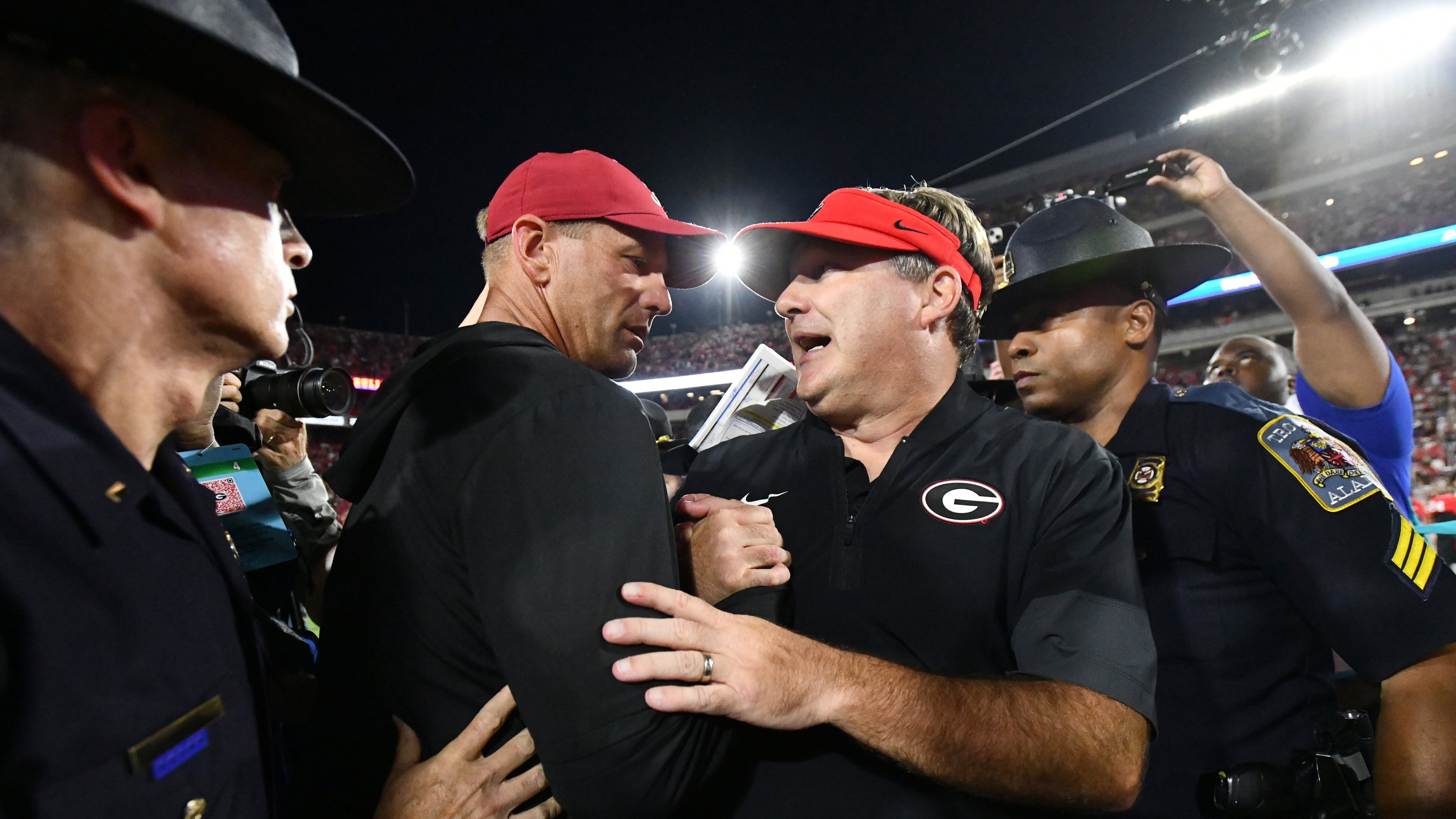 Georgia head coach Kirby Smart (right) and Alabama head coach Kalen DeBoer shake hands after Alabama beat Georgia in an NCAA football game at Sanford Stadium, Saturday, Sept. 27, 2025, in Athens. (Hyosub Shin/AJC)