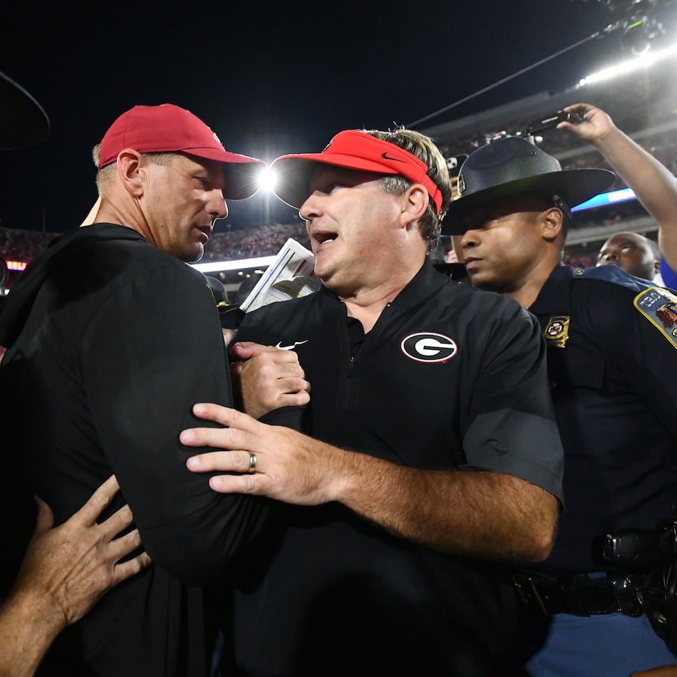 Georgia head coach Kirby Smart (right) and Alabama head coach Kalen DeBoer shake hands after Alabama beat Georgia in an NCAA football game at Sanford Stadium, Saturday, Sept. 27, 2025, in Athens. (Hyosub Shin/AJC)