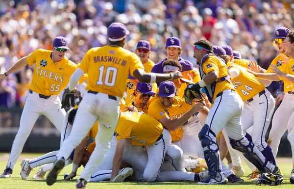 LSU players pile up as they celebrate their 5-3 win against Coastal Carolina in Game 2 of the NCAA College World Series baseball finals in Omaha, Neb., Sunday, June 22, 2025. (AP Photo/Rebecca S. Gratz)