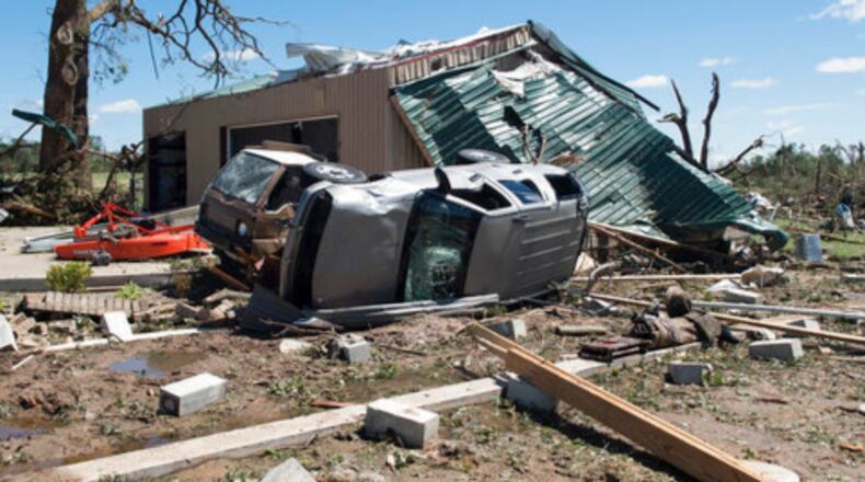 An overturned vehicle rests on the ground surrounded by debris in Canton, Texas, Sunday, April 30, 2017 after tornadoes hit the area the previous night. Severe storms including tornadoes swept through several small towns in East Texas, killing several people, and leaving a trail of overturned vehicles, mangled trees and damaged homes, authorities said Sunday. (Sarah A. Miller/Tyler Morning Telegraph)