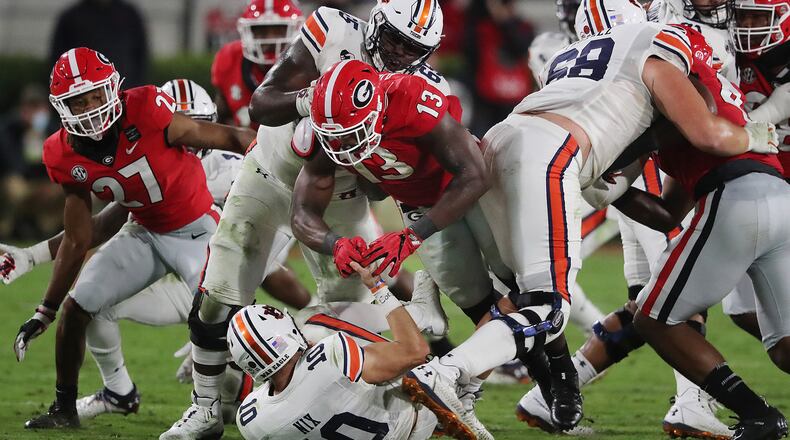 Georgia linebacker Azeez Ojulari (13) makes life miserable for Auburn quarterback Bo Nix in Athens. (Curtis Compton/Atlanta Journal-Constitution/TNS)