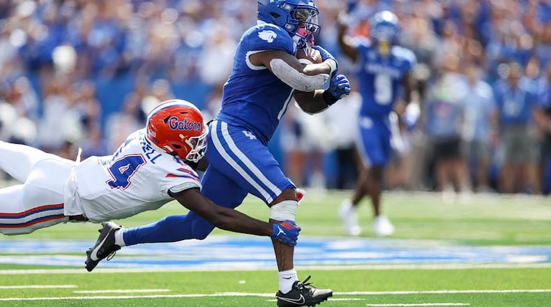 Kentucky running back Ray Davis (1) picks up a first down before being tackled by Florida safety Jordan Castell at Kroger Field on Saturday, Sept. 30, 2023, in Lexington, Kentucky. (Silas Walker/Lexington Herald-Leader/TNS)