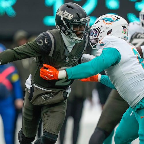 New York Jets quarterback Tyrod Taylor (2) avoids a sack by DUPLICATE***Miami Dolphins outside linebacker Matthew Judon (8) during the first quarter of an NFL football game, Sunday, Dec. 7, 2025, in East Rutherford, N.J. (AP Photo/Yuki Iwamura)