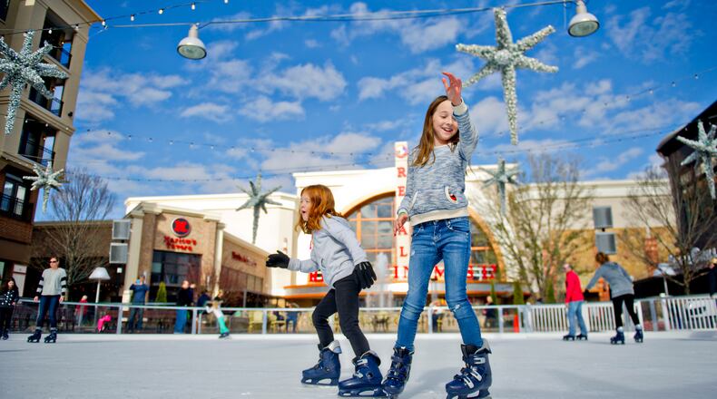 Abby Ostwald (right) and Emma Seher skate on the ice rink at Avalon in Alpharetta on Sunday, Nov. 30, 2014. The rink will be open most days through February 2015. JONATHAN PHILLIPS / SPECIAL