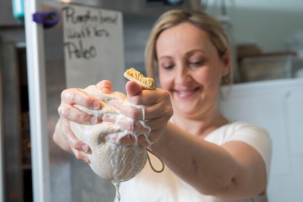 Cristy Kisner, owner of Christy Kitchen, prepares almond milk for customers at her restaurant in Roswell. (Daniel Varnado / For the AJC)