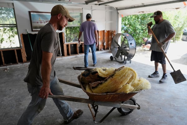 Volunteers help clean up a house after flooding in Kerrville, Texas on Tuesday, July 8, 2025. (AP Photo/Ashley Landis)