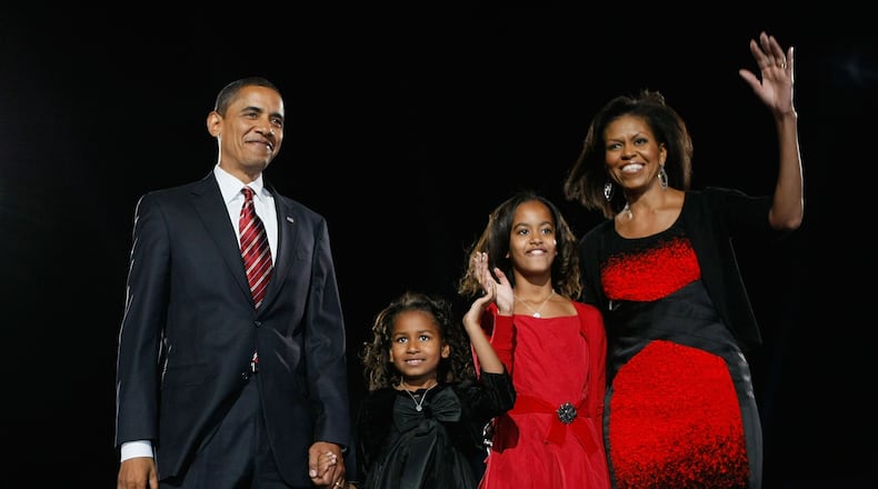 U.S. President elect Barack Obama stands on stage along with his family during an election night gathering in Grant Park on November 4, 2008 in Chicago, Illinois. (Photo by Joe Raedle/Getty Images)