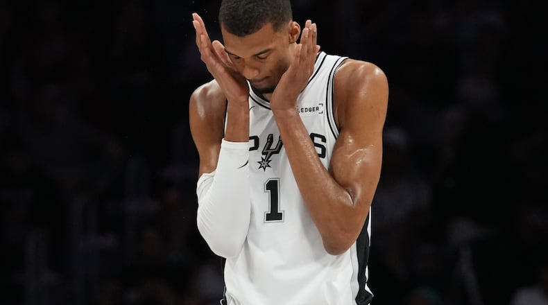 San Antonio Spurs forward Victor Wembanyama (1) walks on the court during the first half of an NBA basketball game against the Miami Heat, Monday, March 23, 2026, in Miami. (AP Photo/Lynne Sladky)