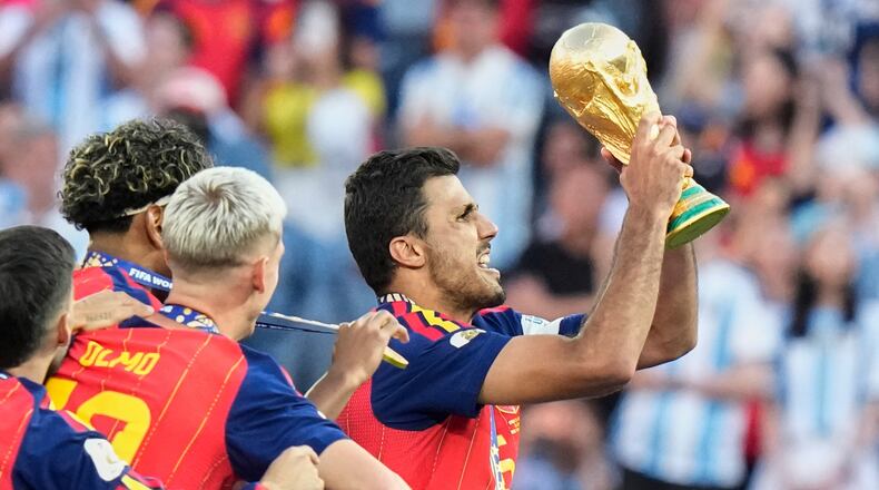 Spain's Rodri (16) lifts the winners' trophy after their win in the World Cup final soccer match against Argentina in East Rutherford, N.J., near New York, Sunday, July 19, 2026. (AP Photo/Frank Franklin II)