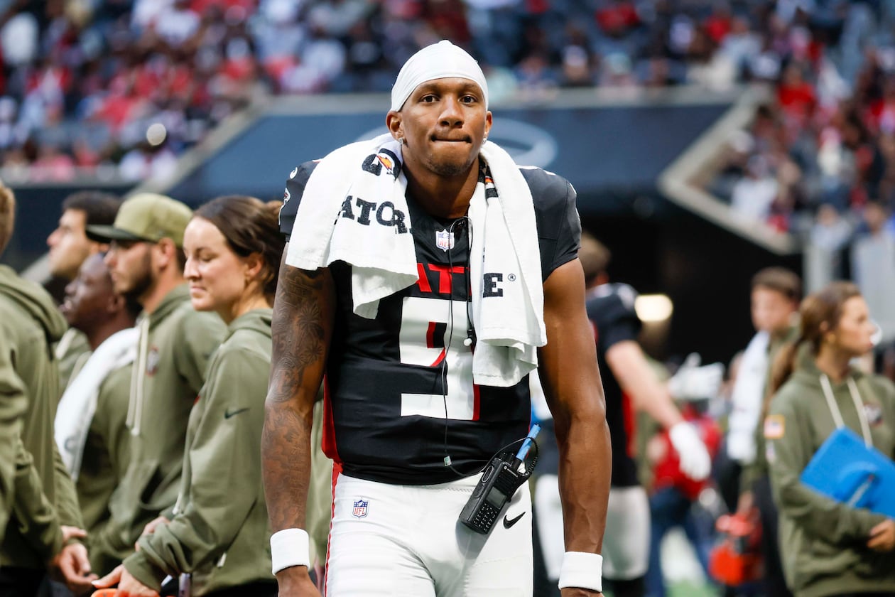 Falcons quarterback Michael Penix Jr. stands on the sidelines after leaving the field with an apparent injury during the second half against the Carolina Panthers at Mercedes-Benz Stadium on Sunday, Nov. 16, 2025, in Atlanta. (Miguel Martinez/AJC)