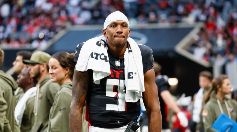 Falcons quarterback Michael Penix Jr. stands on the sidelines after leaving the field with an apparent injury during the second half against the Carolina Panthers at Mercedes-Benz Stadium on Sunday, Nov. 16, 2025, in Atlanta. (Miguel Martinez/AJC)