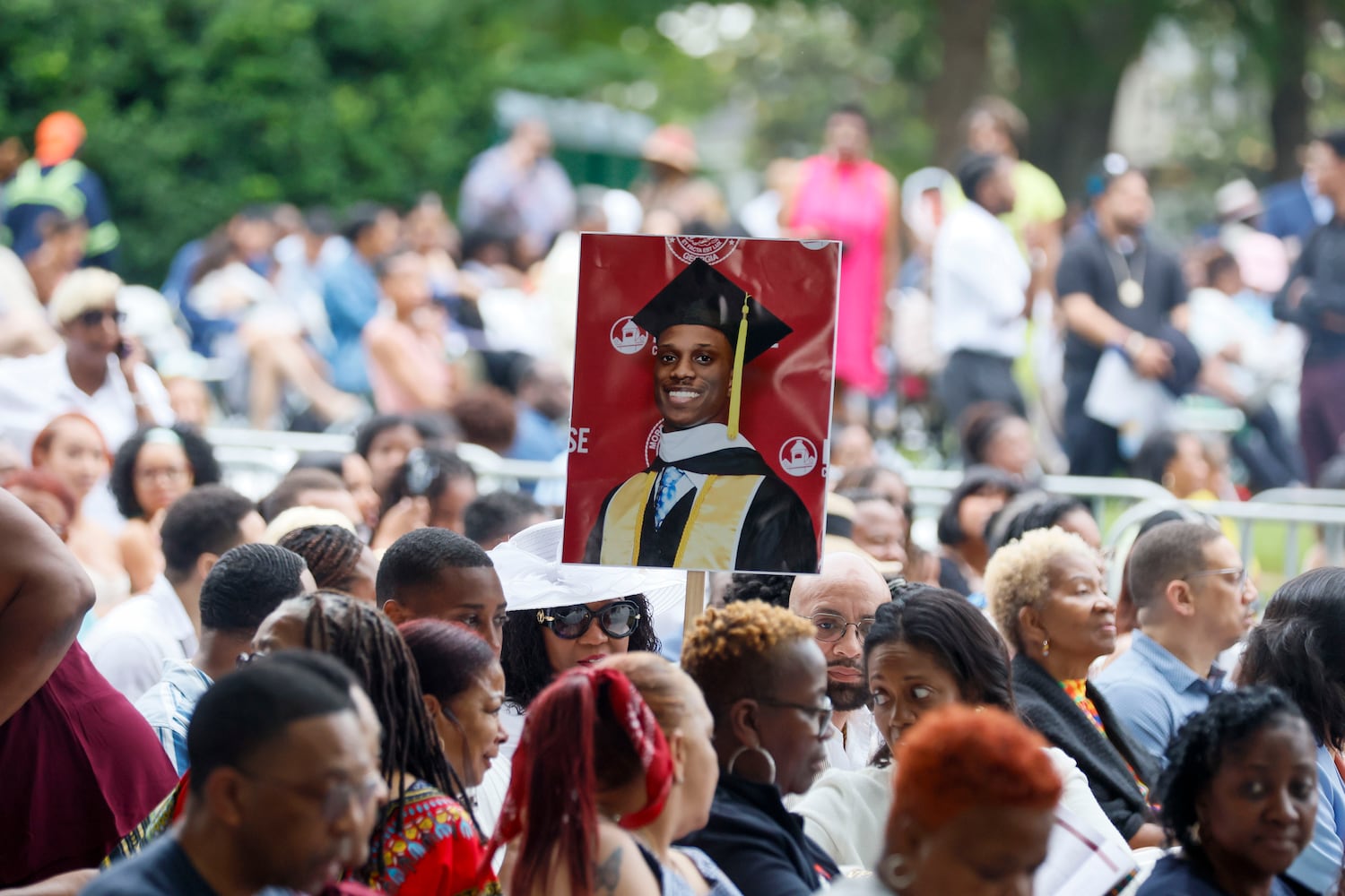 A family member holds a photo of a graduate during Morehouse College's 141st Commencement Ceremony on Sunday, May 18, 2025.
 (Miguel Martinez/ AJC)