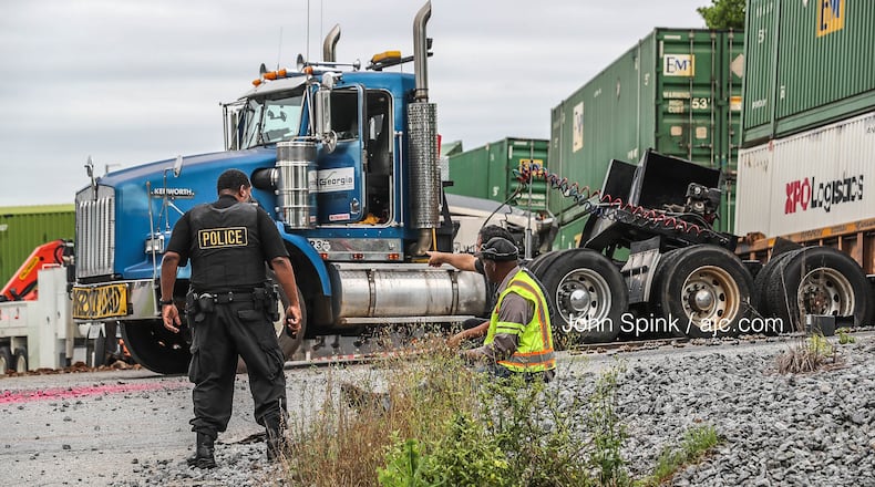 The train derailed after hitting a semitruck that was stuck on the tracks.