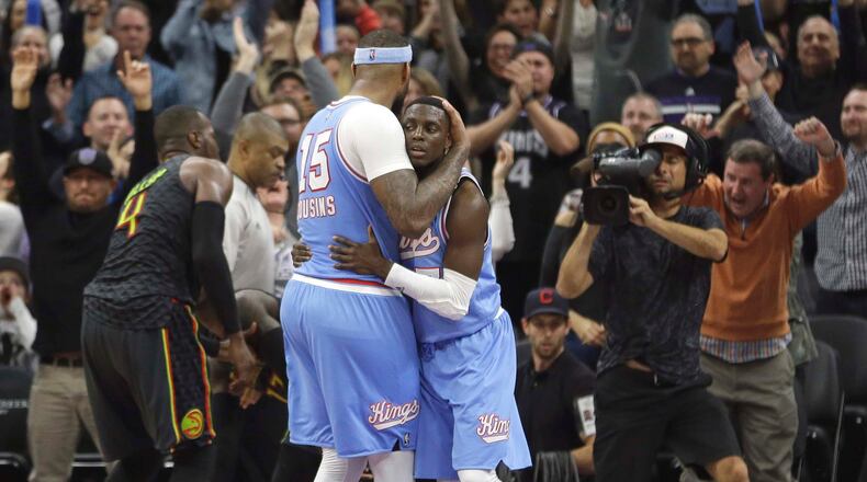Sacramento Kings forward DeMarcus Cousins, left, hugs teammate Darren Collison, right, after he made the game winning basket in the final moments of the Kings 108-107 win over the Atlanta Hawks, in an NBA basketball game Friday, Feb. 10, 2017, in Sacramento, Calif. (AP Photo/Rich Pedroncelli)