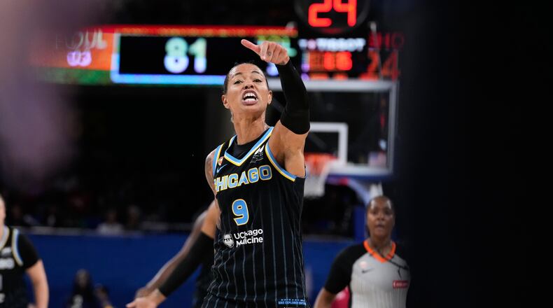 Chicago Sky guard Natasha Cloud argues with former NBA center Enes Kanter Freedom, right, during the second half of a WNBA basketball game against the Indiana Fever, Sunday, Aug. 23, 2026, in Chicago. (AP Photo/Nam Y. Huh)