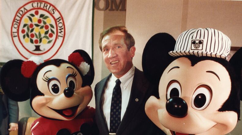 Minnie Mouse and Mickey Mouse are on hand as Tech coach Bobby Ross accepts a spot in the Citrus Bowl in 1990. Walter Stricklin / AJC