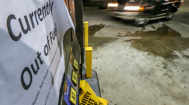 Some gas stations had bags over their pumps and no pricing on their gas signs on Monday. JOHN SPINK /JSPINK@AJC.COM