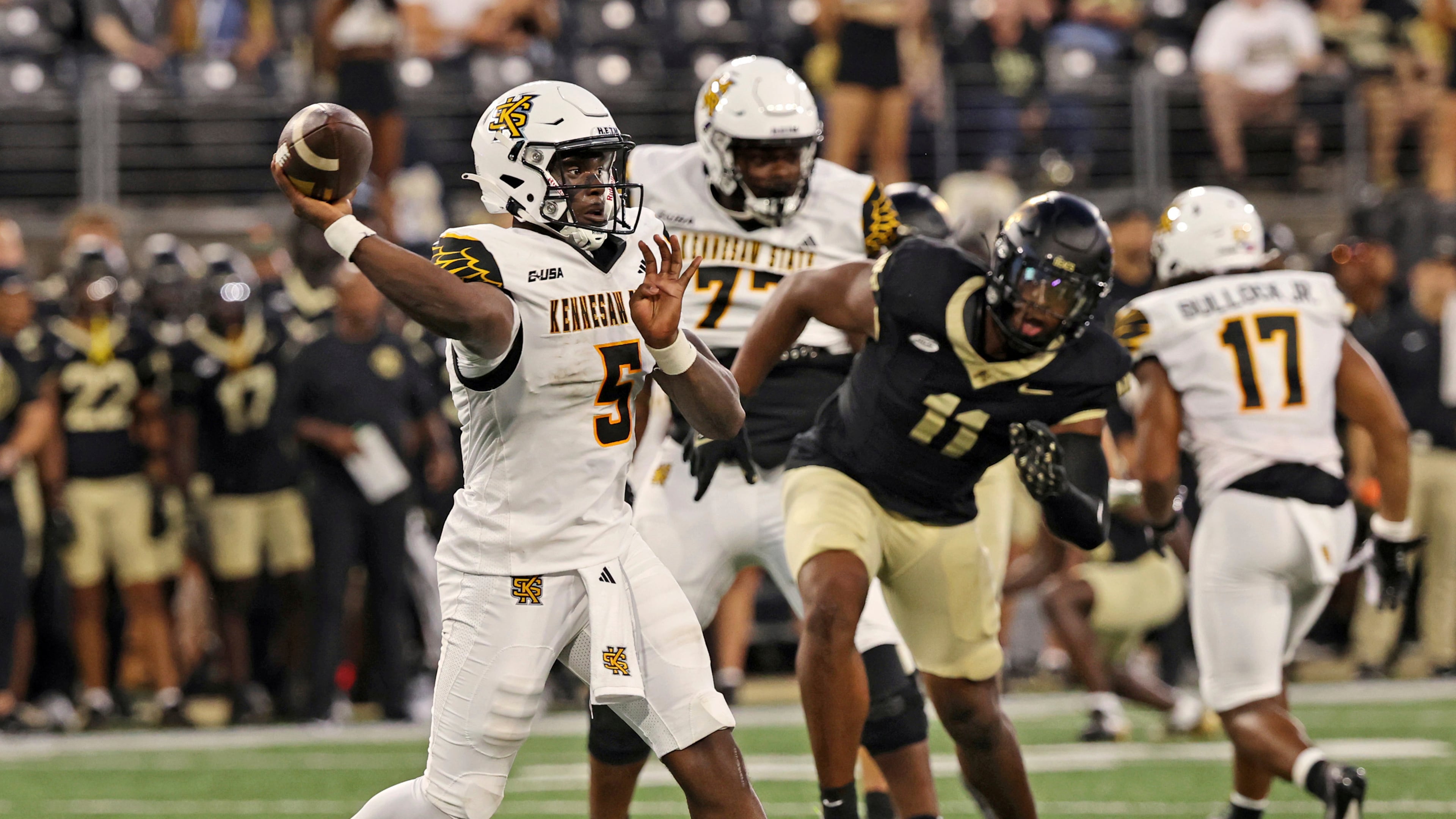 Kennesaw State quarterback Dexter Williams II, left, looks to throw against Wake Forest in the first half of an NCAA college football game Friday, Aug. 29, 2025, in Winston-Salem, N.C. (Walt Unks/The Winston-Salem Journal via AP)
