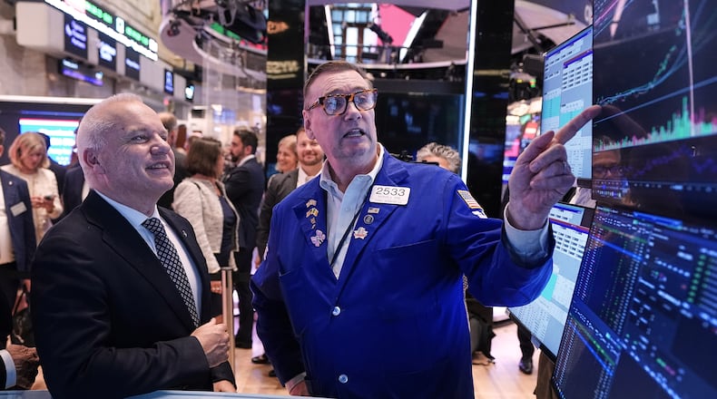 Anders Opedal, President and CEO of Norway's Equinor, left, meets with specialist Patrick King on the floor of the New York Stock Exchange, after he rang the closing bell, Tuesday, June 16, 2026. (AP Photo/Richard Drew)