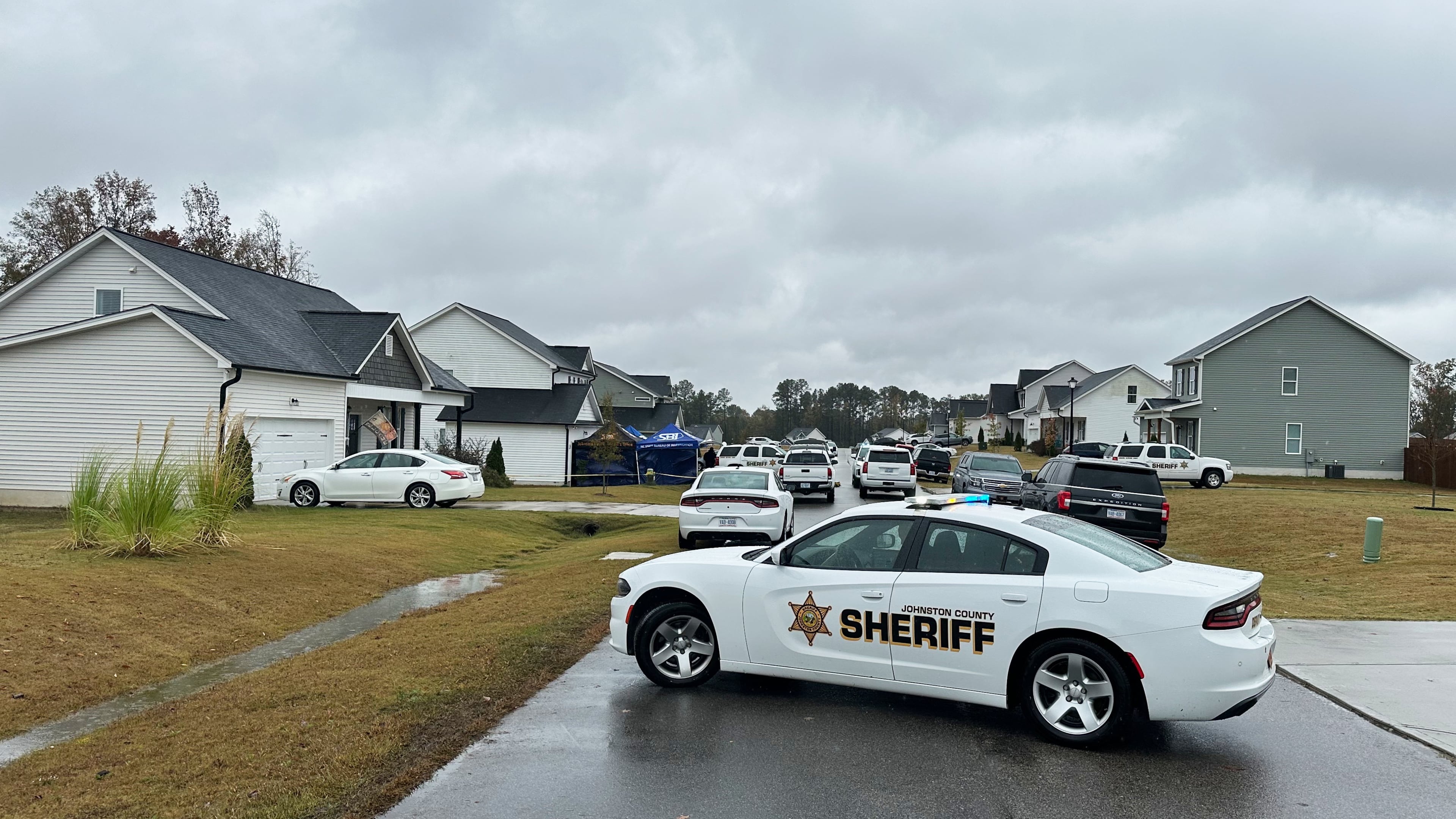 Law enforcement vehicles block the road to Wellington Delano Dickens III's home, where remains were found after Dickens told authorities he had killed four of his children, in Zebulon, N.C., on Tuesday, Oct. 28, 2025. (AP Photo/Allen G. Breed)