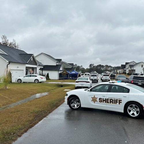 Law enforcement vehicles block the road to Wellington Delano Dickens III's home, where remains were found after Dickens told authorities he had killed four of his children, in Zebulon, N.C., on Tuesday, Oct. 28, 2025. (AP Photo/Allen G. Breed)