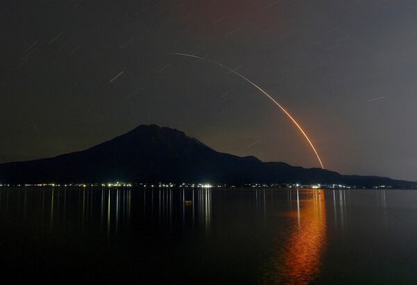 In this long exposure photo, an H-2A rocket carrying Global Observing SATellite for Greenhouse gases and Water cycle, or GOSAT-GW satellite, lifts off from Tanegashima Space Center, seen in Kagoshima, southern Japan, early Sunday, June 29, 2025. (Kotaro Ueda/Kyodo News via AP)
