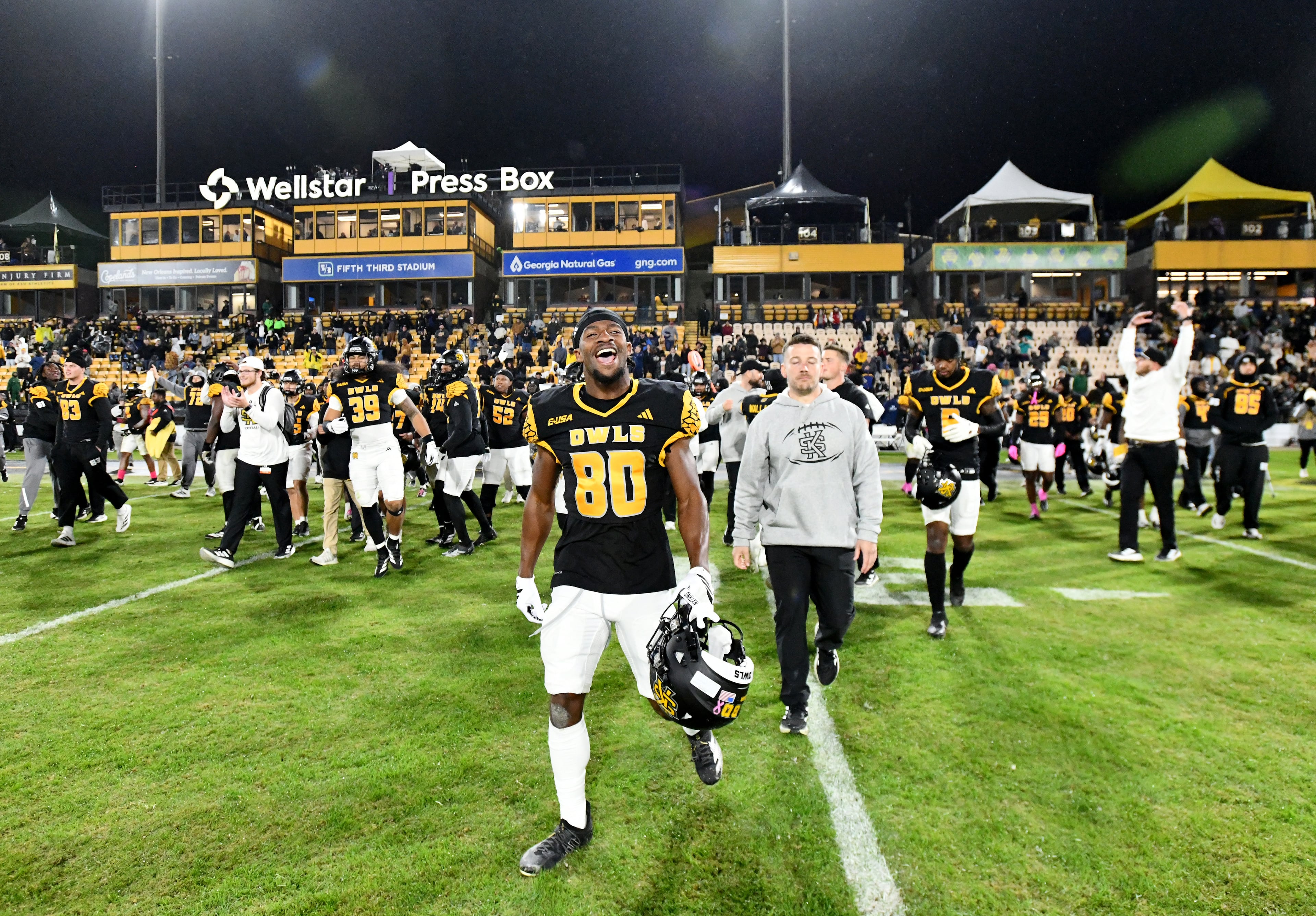 Kennesaw State players coaching staff celebrate after Kennesaw State beat UTEP during an NCAA college football game at Fifth Third Stadium, Tuesday, October 28, 2025 in Kennesaw. Kennesaw State won 33-20 over University of Texas at El Paso. (Hyosub Shin / AJC)