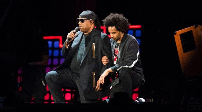 Stevie Wonder, left, takes a knee "for the country" with his son, Kwame Morris, before performing at the 2017 Global Citizen Festival in Central Park, Saturday, Sept. 23, 2017, in New York. The festival aims to end extreme poverty through the collective actions of Global Citizens by 2030. (AP Photo/Michael Noble Jr.)
