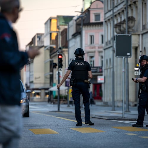 Police officers patrol a street in downtown Aarau, Switzerland Sunday, Aug. 30, 2026, following a shooting at a rave. (Michael Buholzer/Keystone via AP)