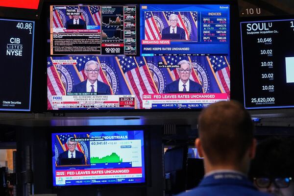 Screens on a trading post on the floor of the New York Stock Exchange show the news conference of Federal Reserve Chair Jerome Powell, Wednesday, May 7, 2025. (AP Photo/Richard Drew)