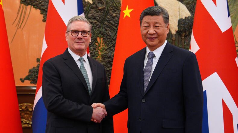 Britain's Prime Minister Keir Starmer, left, shakes hands with Chinese President Xi Jinping ahead of a bilateral meeting in Beijing, China, Thursday, Jan.29, 2026. (Carl Court/Pool Photo via AP)