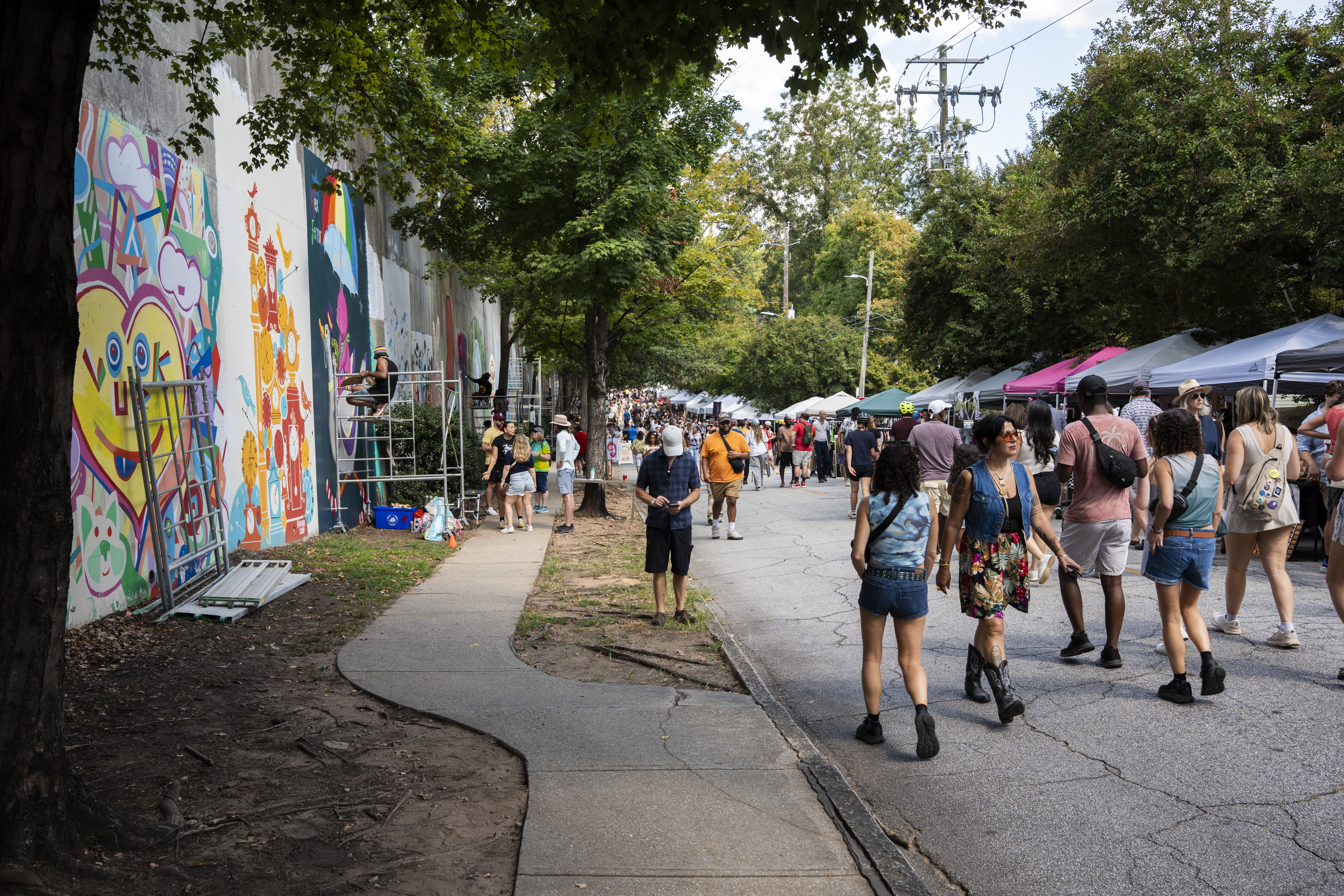 Local artists create murals live at the 11th annual Forward Warrior festival in the Cabbagetown neighborhood of Atlanta on Saturday, Sept. 13, 2025. (Olivia Bowdoin for the AJC)