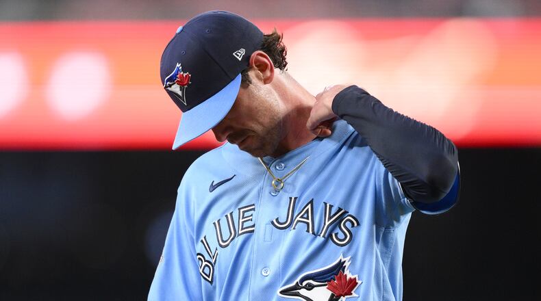 Toronto Blue Jays pitcher Shane Bieber walks back to the dugout after he was pulled from a baseball game in the first inning against the Washington Nationals, Tuesday, July 28, 2026, in Washington. (AP Photo/Nick Wass)