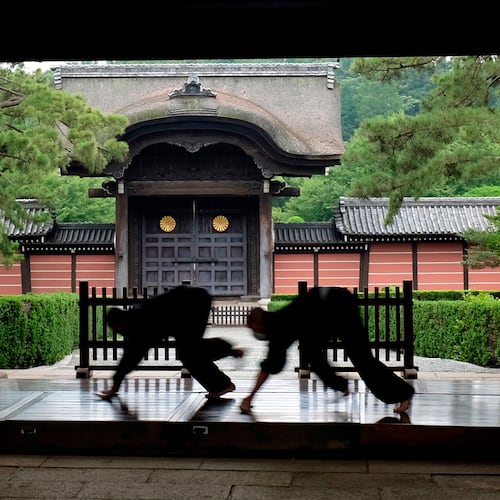 FILE - Monks polish the wooden corridor of the walkway that connects between temple buildings at Soji-ji in Yokohama, Japan on July 5, 2016. (AP Photo/Kiichiro Sato, File)