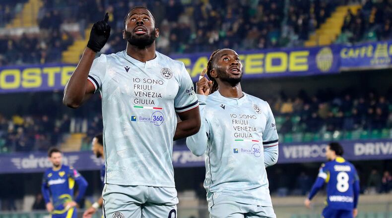 Udinese's Keinan Davis, left, celebrates after scoring their third goal during the Serie A soccer match between Hellas Verona and Udinese in Verona, Italy, Monday Jan. 26, 2026. (Paola Garbuio/LaPresse via AP)