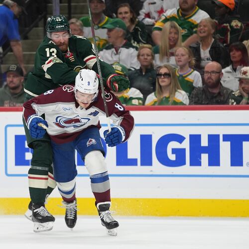 Minnesota Wild center Yakov Trenin (13) pushes Colorado Avalanche defenseman Cale Makar (8) during the first period of Game 4 in a second-round NHL hockey Stanley Cup playoff series Monday, May 11, 2026, in St. Paul, Minn. (AP Photo/Abbie Parr)