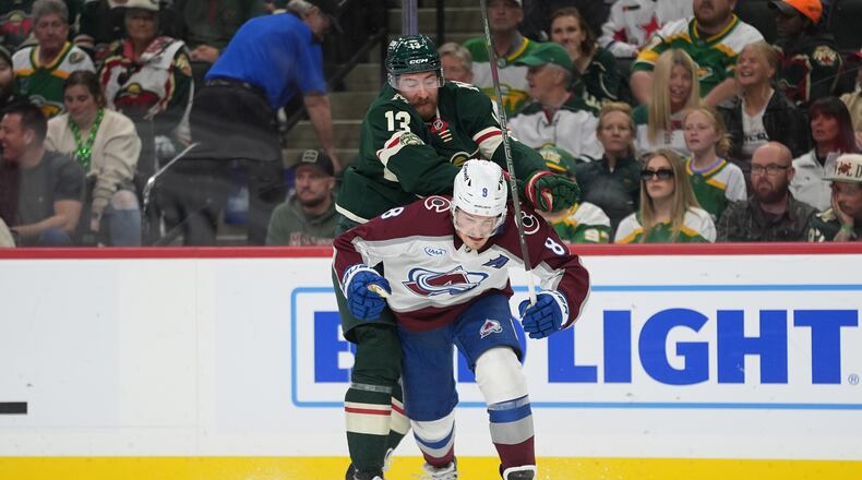 Minnesota Wild center Yakov Trenin (13) pushes Colorado Avalanche defenseman Cale Makar (8) during the first period of Game 4 in a second-round NHL hockey Stanley Cup playoff series Monday, May 11, 2026, in St. Paul, Minn. (AP Photo/Abbie Parr)