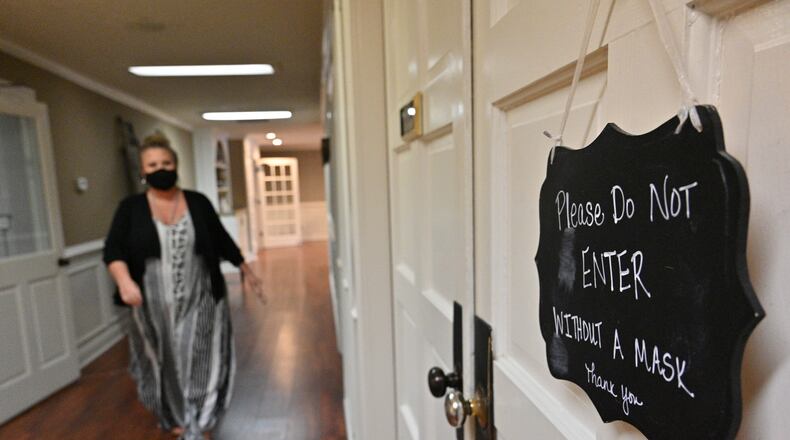 May 25, 2022 Snellville - Adrienne Levesque walks back to her office at Summit Chase Country Club in Snellville on Wednesday, May 25, 2022. Adrienne Levesque has been dealing with long Covid and has had cardiac issues ever since she got sick with COVID in 2020. She has been going to a long Covid clinic and sees a cardiologist. (Hyosub Shin / Hyosub.Shin@ajc.com)