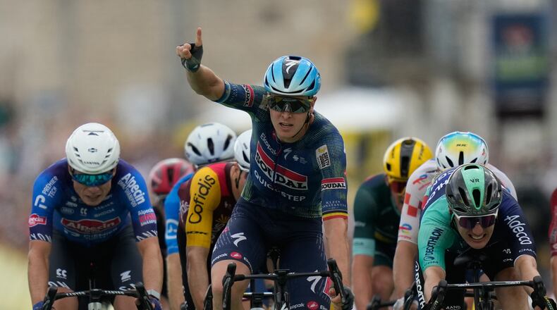 Belgium's Tim Merlier celebrates as he crosses the finish line to win the twelfth stage of the Tour de France cycling race with start in Circuit Nevers Magny-Cours and finish in Chalon-sur-Saone, France, Thursday, July 16, 2026. (AP Photo/Mosa'ab Elshamy)