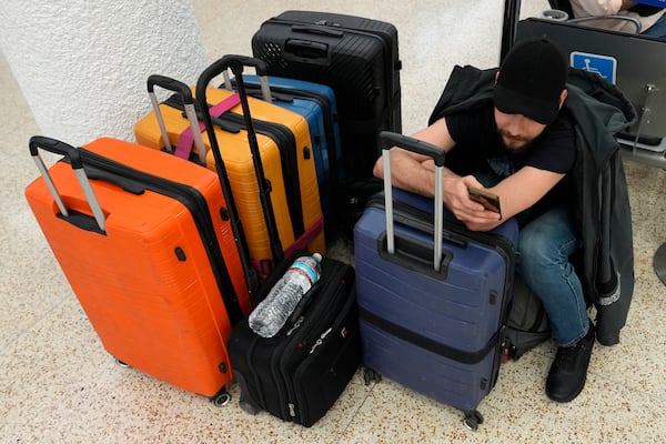 FILE - Pasha Pidlubniak waits for a domestic flight at the international airport ahead of the Memorial Day holiday, in Miami, May 23, 2024. (AP Photo/Lynne Sladky)