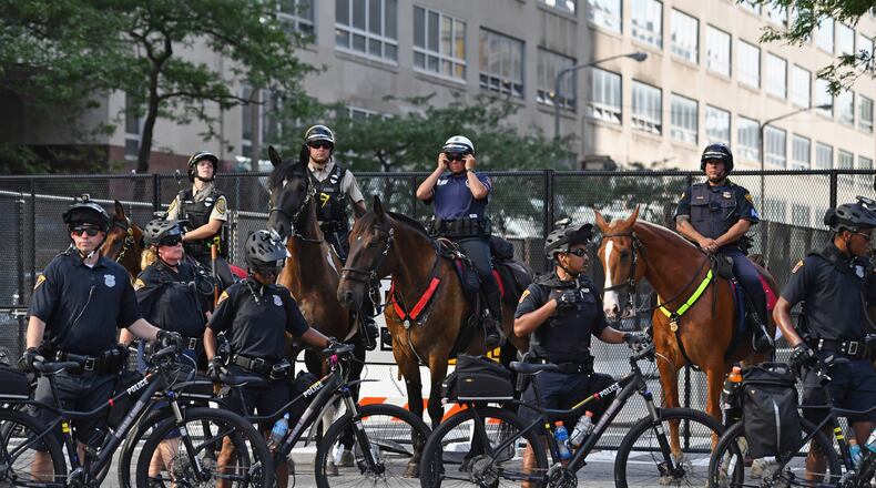 Police look on as demonstrators march through downtown ahead of the Republican National Convention on Sunday in Cleveland. An estimated 50,000 people are expected in Cleveland, including hundreds of protesters and members of the media. The four-day Republican National Convention kicks off on Monday. Jeff J Mitchell/Getty Images