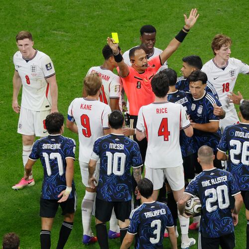 Referee Ismail Elfath awards a yellow card to England's Elliot Anderson, upper left, for a foul on Argentina's Lionel Messi during first half of Argentina vs. England FIFA World Cup Semifinal match at Atlanta Stadium (Mercedes-Benz Stadium) on Wednesday, July 15, 2026. (Miguel Martinez/AJC)