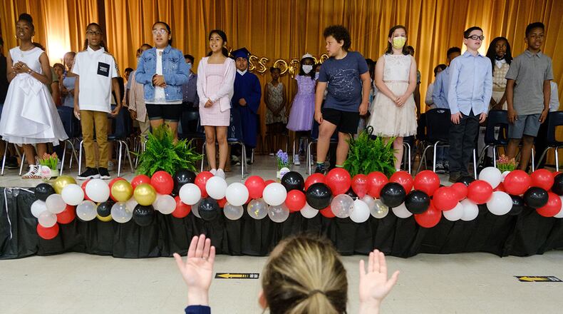 Fifth graders sing a song on stage at their graduation ceremony at Hawthorne Elementary School in Atlanta on Friday, May 20, 2022. Hawthorne Elementary is one of 16 schools in the DeKalb County district recognized for having the most improvement in content mastery scores on state assessments in recent years. (Arvin Temkar / arvin.temkar@ajc.com)