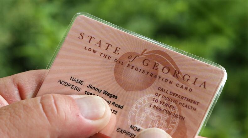 After battling for years to help treat his daughter, Sydney, with cannabis oil, J-Bo Wages finally holds his state of Georgia low-THC cannabis oil registration card. Curtis Compton / ccompton@ajc.com